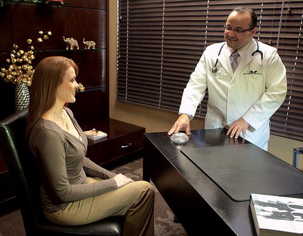 Dr. Aldo in a breast augmentation consultation with a patient.